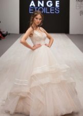A puffy wedding dress with a layered skirt