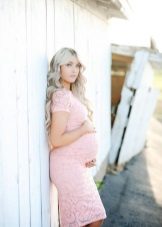 Photoshoot of a pregnant woman in a dress