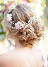 Hairstyle with fresh flowers for a wedding dress
