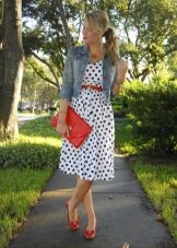 A white dress with blue polka dots combined with red accessories