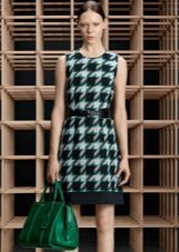 Dress with black and green crow's feet on a white background