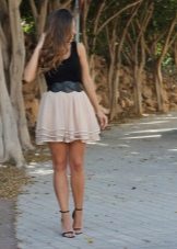 A layered beige skirt combined with a black tank top