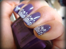 Purple manicure with white lace.