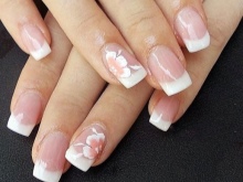 French manicure under an emerald dress