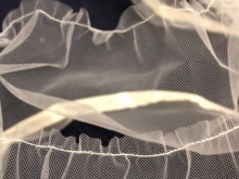 Stitching along the edge of the tulle to tighten the assembly