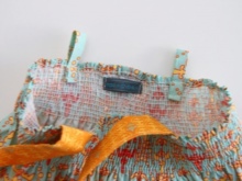 Stitching straps on a dress for a girl