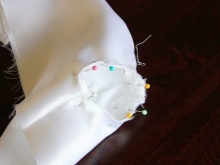 Sewing sleeves to the baptismal dress