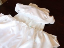 Sewing skirts to the bodice of the baptismal dress
