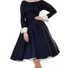 A puffy blue dress with long sleeves and white cuffs on them in the style of the 50s