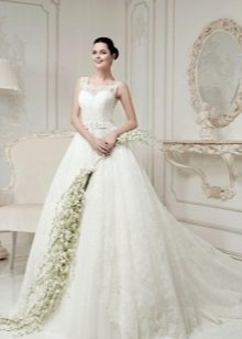 A puffy lace wedding dress with a train