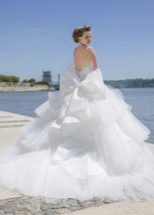 A magnificent wedding dress with a cascading skirt and a train