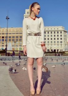 A milk dress combined with bright red jewelry