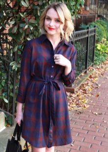 A blue classic cut check shirt dress and a black bag to it