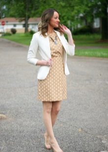 A beige white polka dot formal dress in combination with a white jacket