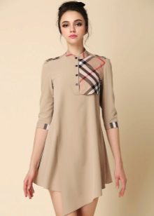 Beige dress with an asymmetrical hem with a plaid insert on the chest