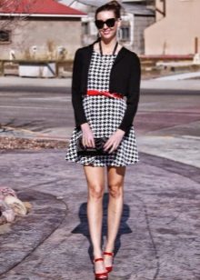 Dress crow's feet in combination with red accessories and a black cardigan