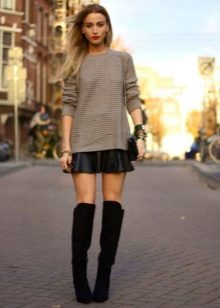 A leather sun skirt combined with suede over the knee boots
