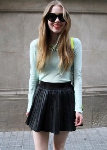 A leather skirt in the sun combined with a mint sweater