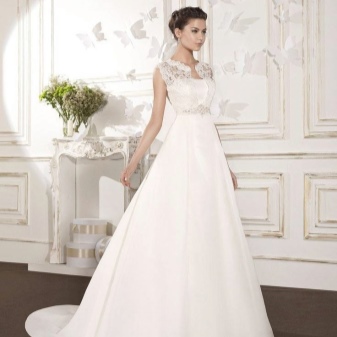 A puffy wedding dress with a satin train