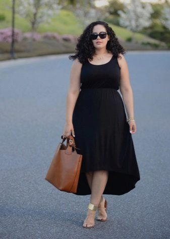A black dress with an asymmetric skirt for complete ones in combination with golden sandals and a brown bag