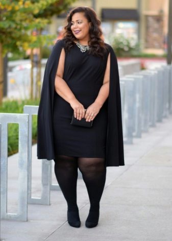 Large black office dress in combination with a cloak and black tights