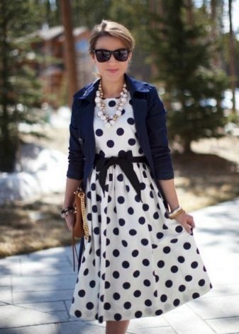 White dress in black polka dots with a black belt