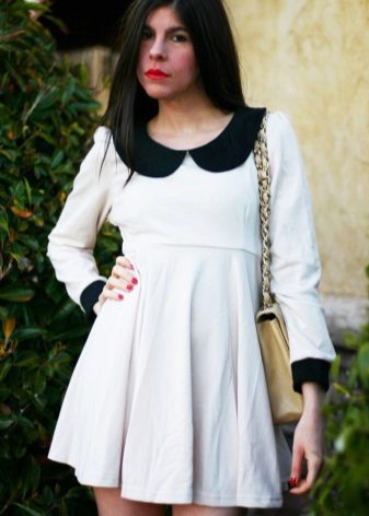 Knitted white high-waisted dress with a black collar and cuffs