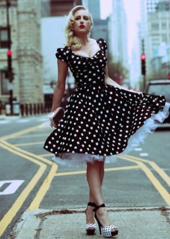 Black dress in white polka dots with a flat layered skirt