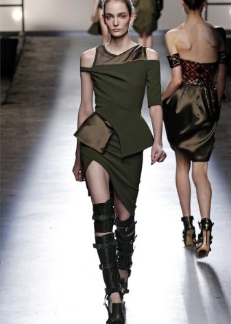 Asymmetrical military dress with high boots on straps
