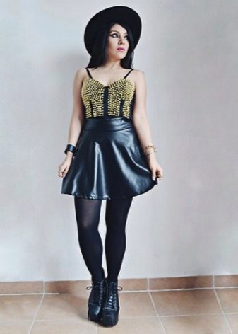 A leather sun skirt combined with a hat, top and wedge high boots