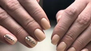 Beautiful manicure with gel polish in nude shades