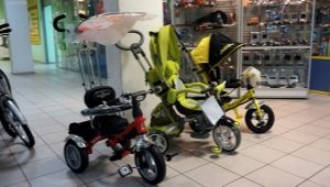 Children's tricycles with a handle