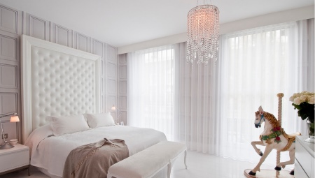 White curtains in the bedroom interior