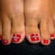 Features of creating a red pedicure with rhinestones