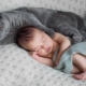 Newborn baby and cat in the apartment