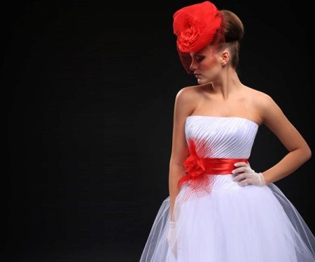 Wedding dress with a red belt and a hat