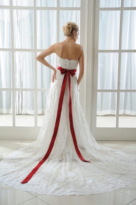 Wedding dress with a red bow on the back