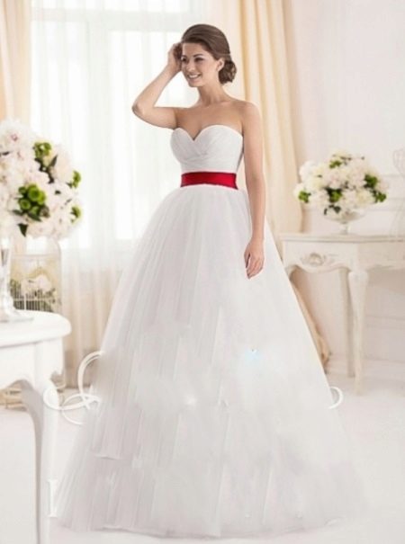 Wedding dress with a cut-out heart and a red belt