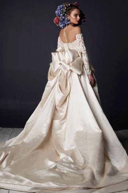 A puffy wedding dress with a train and lace top