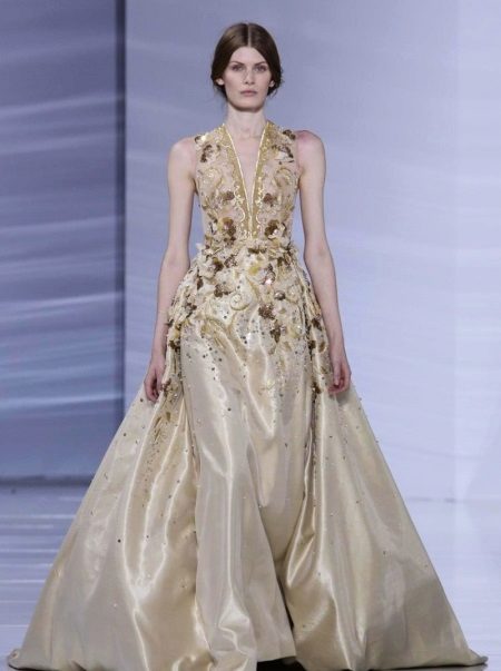 Dress beige evening with a low neck