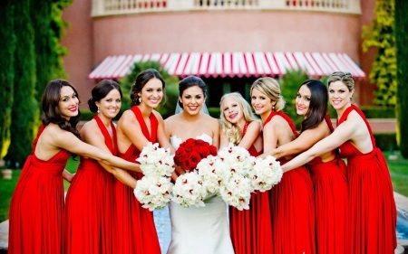 Bride with girlfriends in red dresses